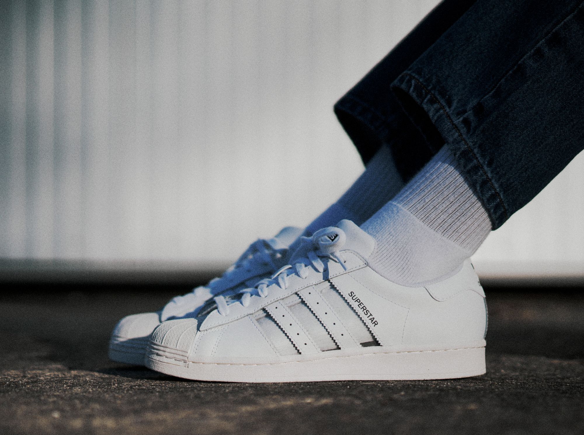 adidas Originals Superstar with transparent stripes on feet shot
