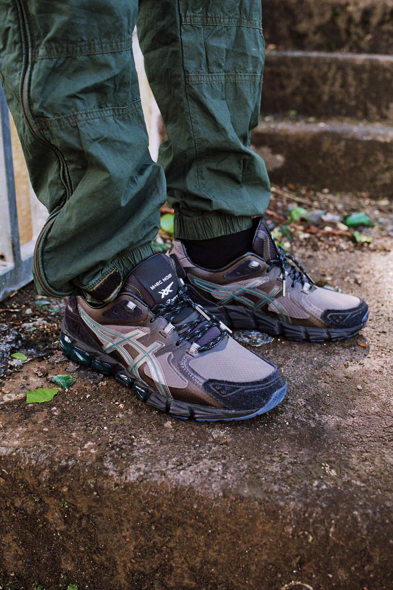 on feet close up of the ASICS x M+RC NOIR - Gel-Quantum 180 6 - graphite grey - 1201A216-020