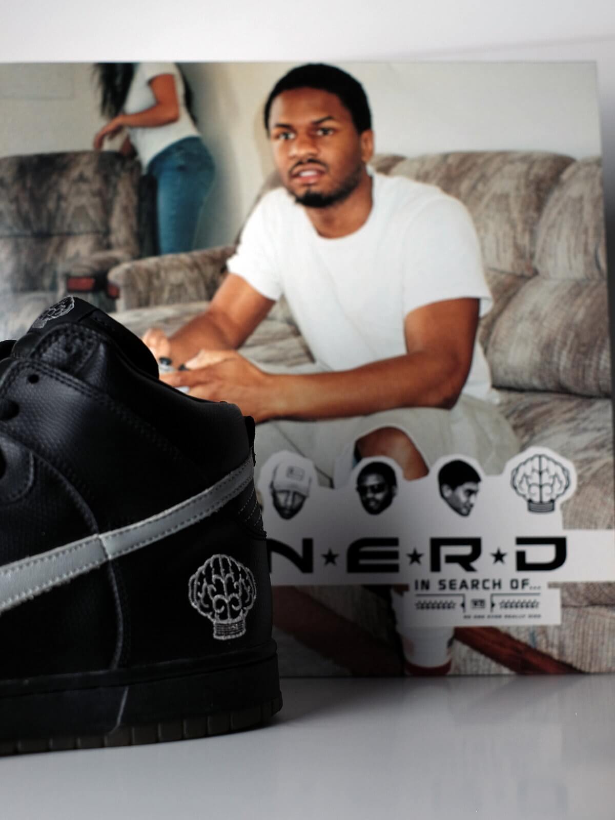 N.E.R.D album cover and Nike x N.E.R.D - Dunk Hi - Artist Series - black/metallic silver/varsity red - 308418-001